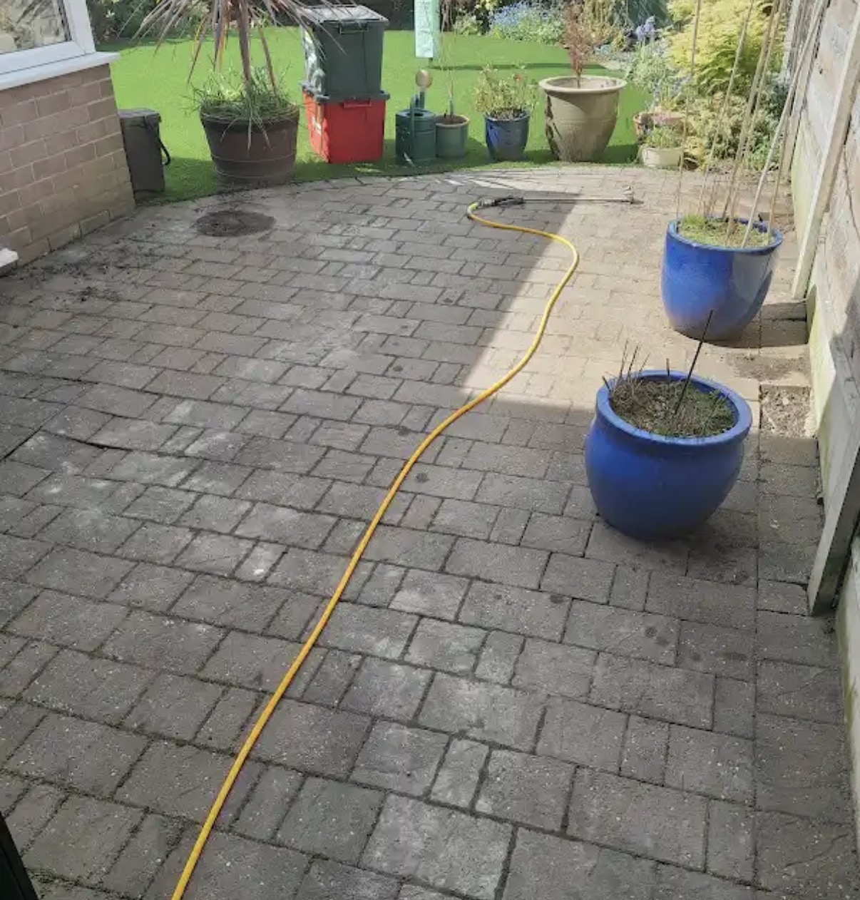 Block-paved driveway before professional power washing